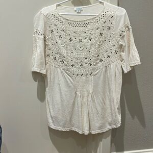 Cream blouse with copper beads on it